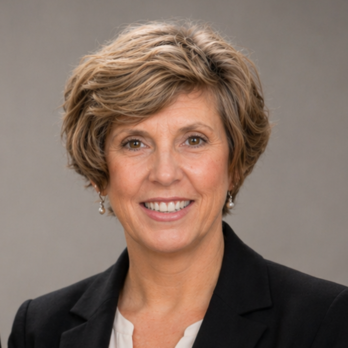 Catherine Hall, licensed residential appraiser and owner of Heritage Valuation Group, smiling in professional attire, emphasizing her expertise in property appraisals across NY, CT, and FL.