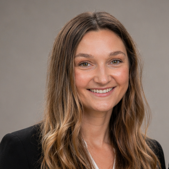 Madeline Hall, licensed residential appraiser, smiling confidently in professional attire, representing Heritage Valuation Group's commitment to accurate residential valuations in Connecticut.
