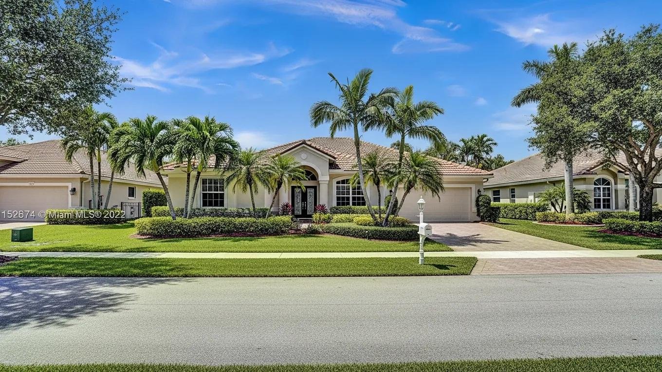 Residential property in Broward County, Florida, showcasing beautiful landscaping and a clear sky, representing home appraisal services